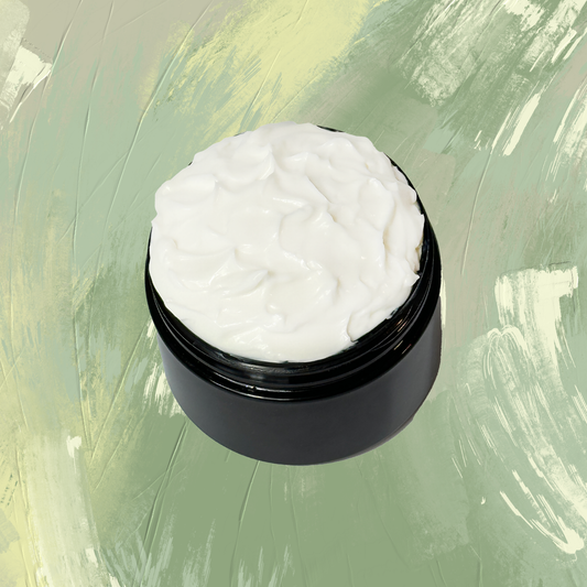 Black jar with white cream on a green textured background
