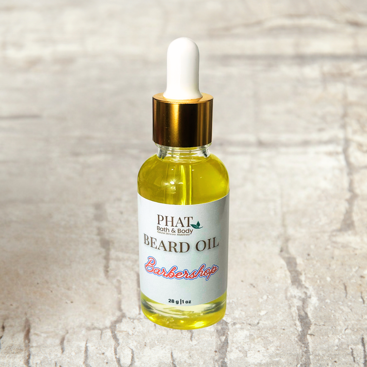 Bottle of Phat Bath & Body beard oil on a textured surface