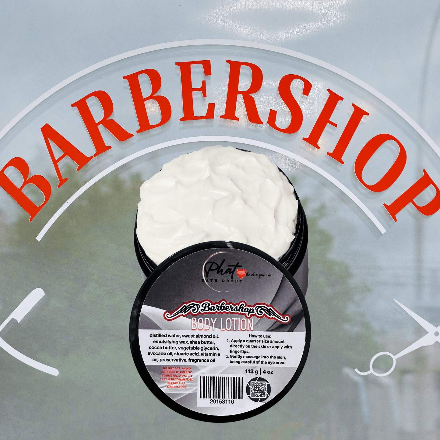 Body lotion container with 'Barbershop' branding on a gray background