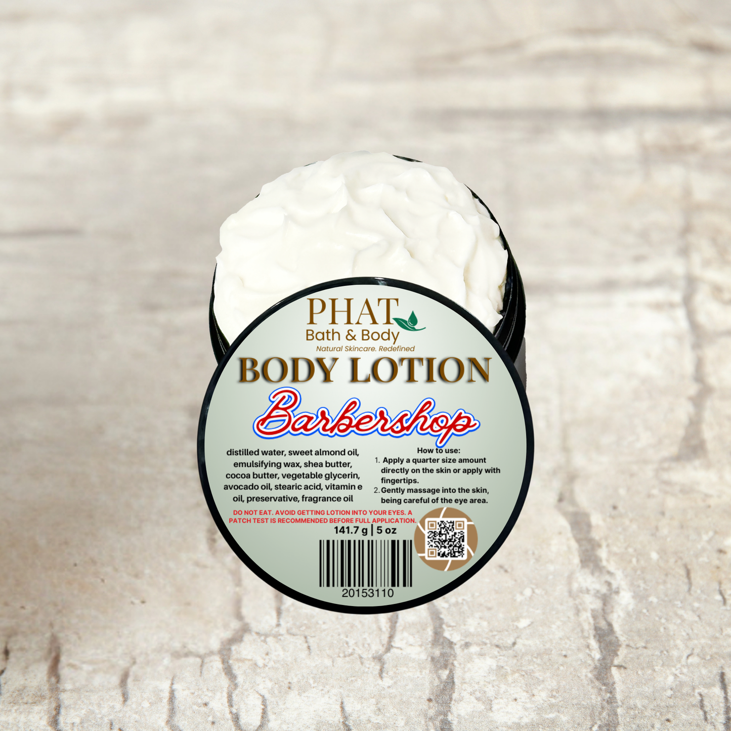 Body lotion container with 'Phat Bath & Body' label on a textured beige background