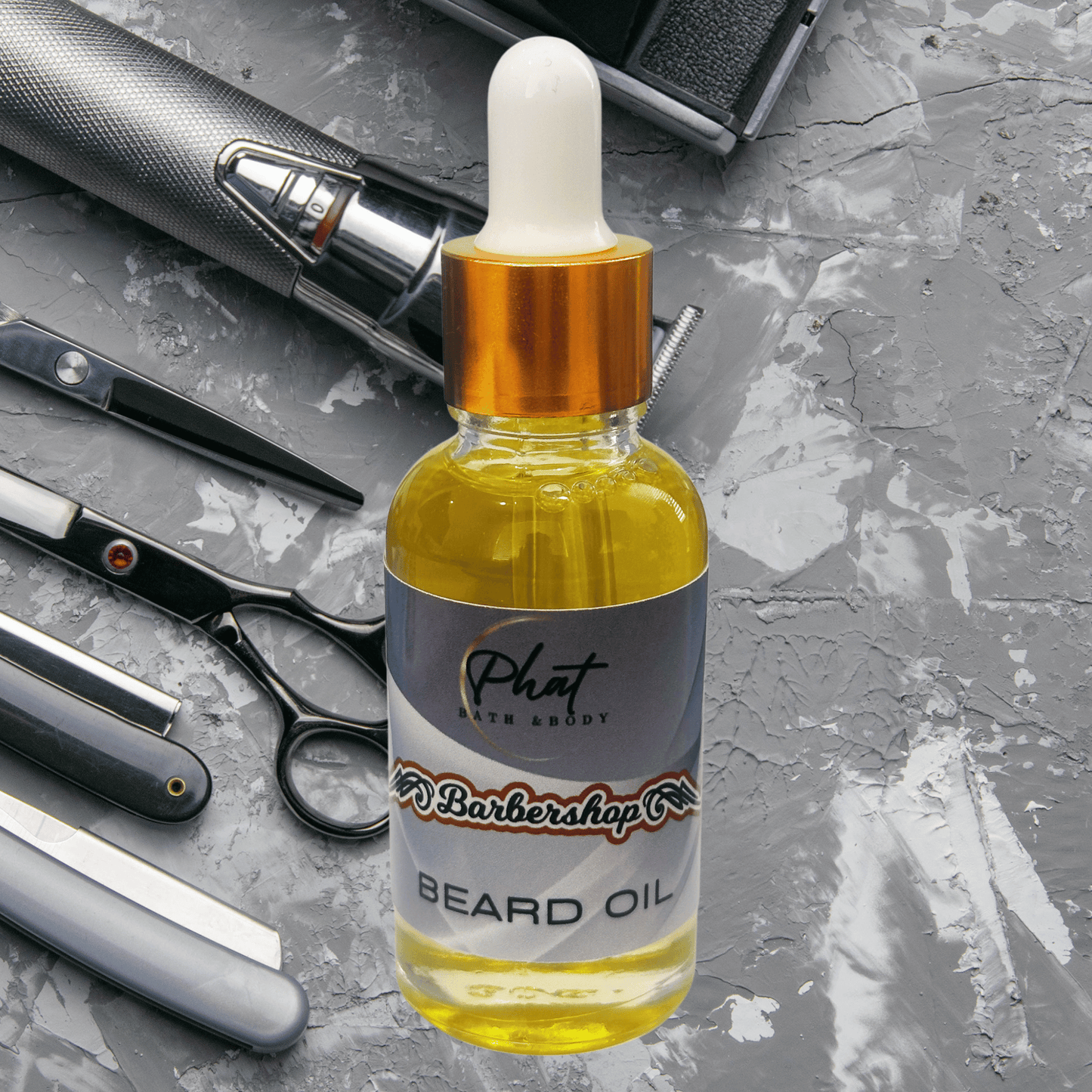 Bottle of Barbershop beard oil with barbershop tools on a gray surface