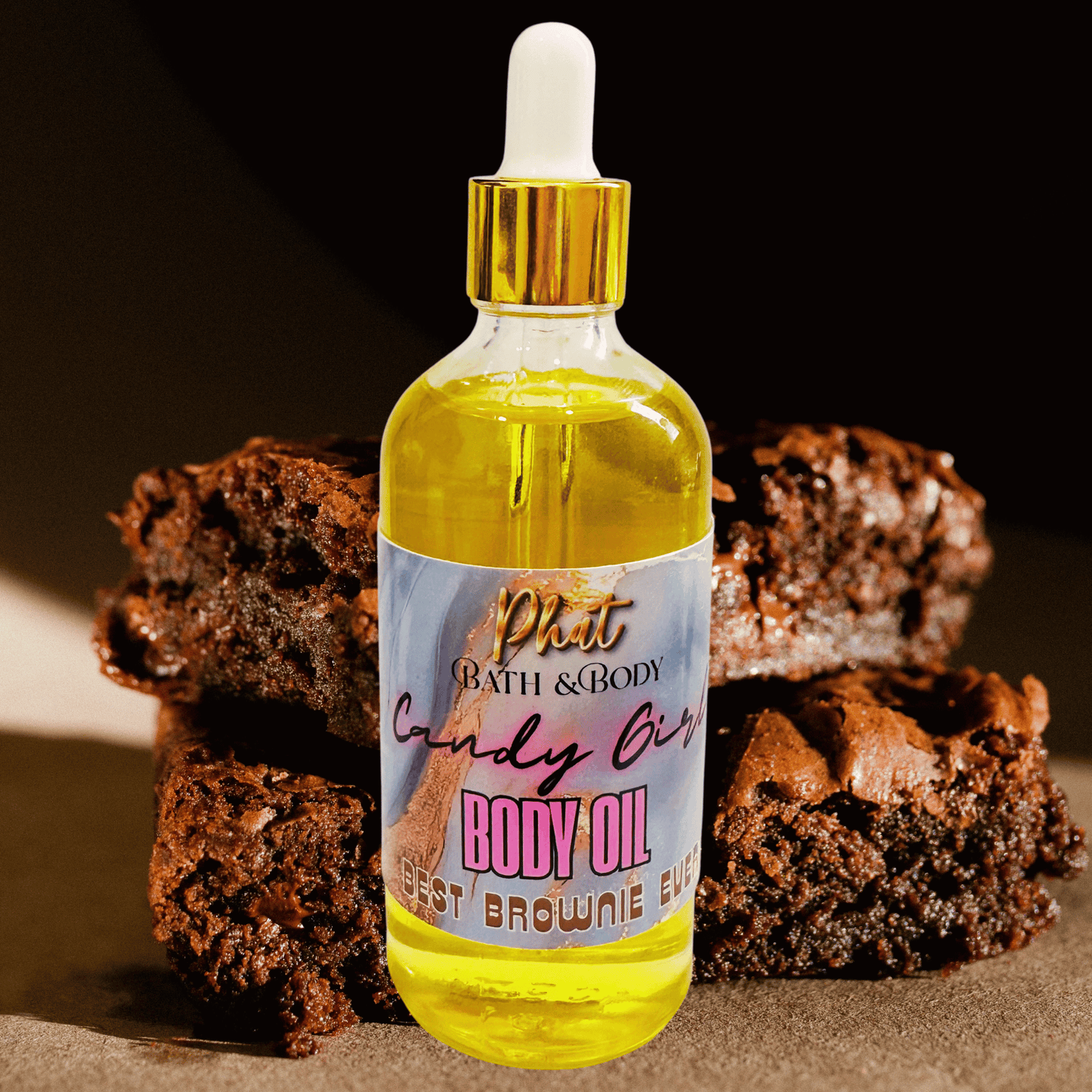 Bottle of body oil with a brownie-themed label in front of brownies