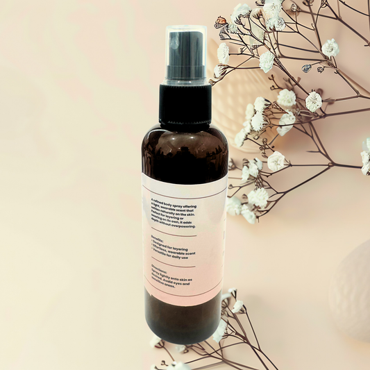 Brown spray bottle with a label on a beige background with white flowers.