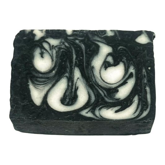 Black and white swirled charcoal soap bar on a white background