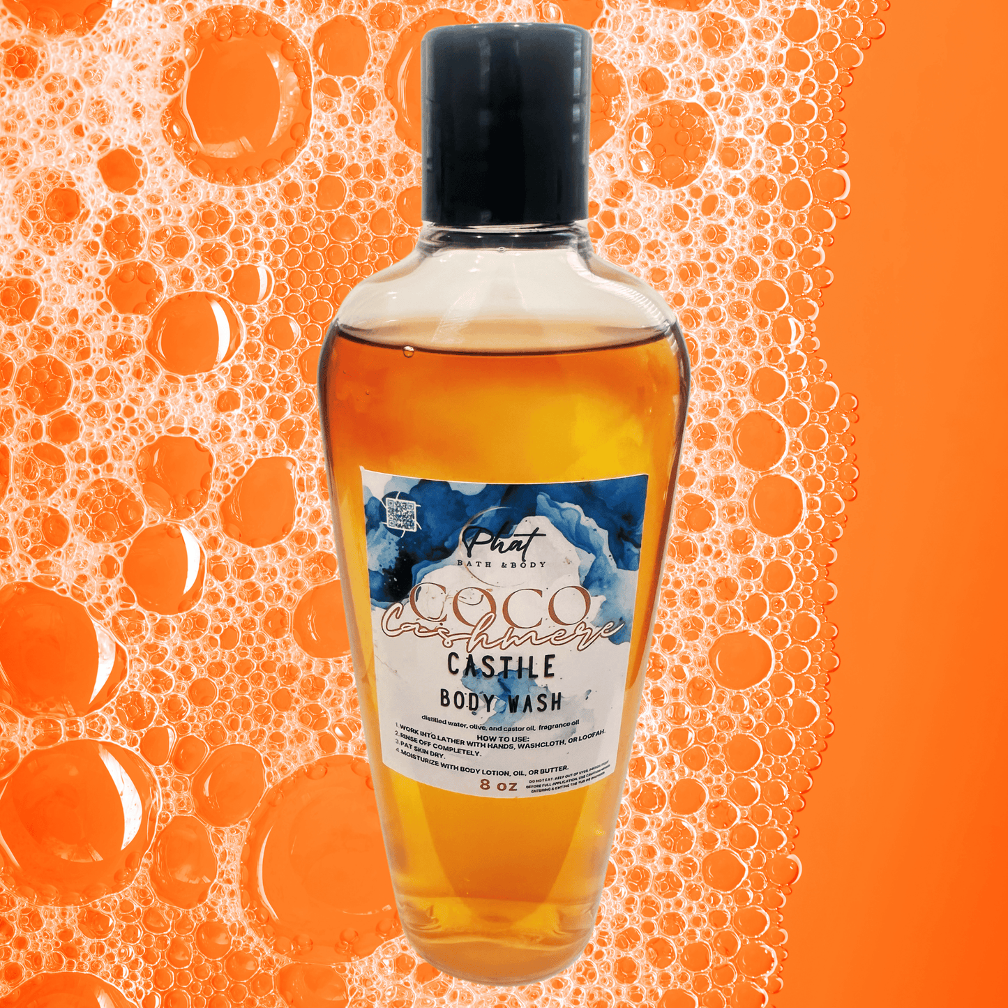 Coco Cashmere body wash on a orange background with bubbles.