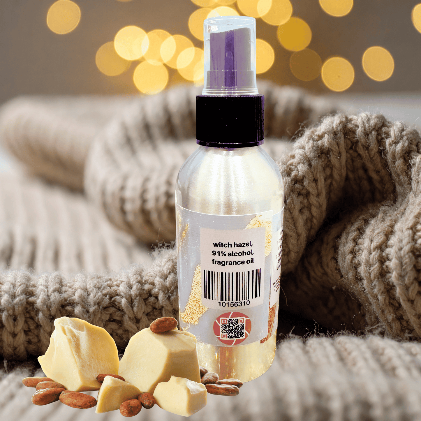 Bottle of body spray with a ingredients label on a textured surface with lights in the background