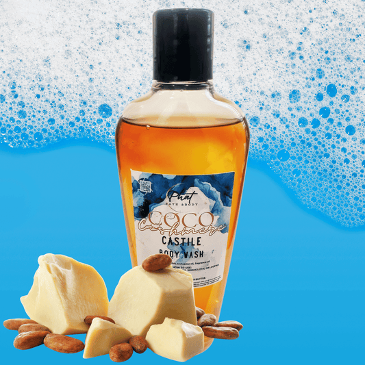 Bottle of Coco Cashmere Castile body wash with cocoa butter chunks on a blue background