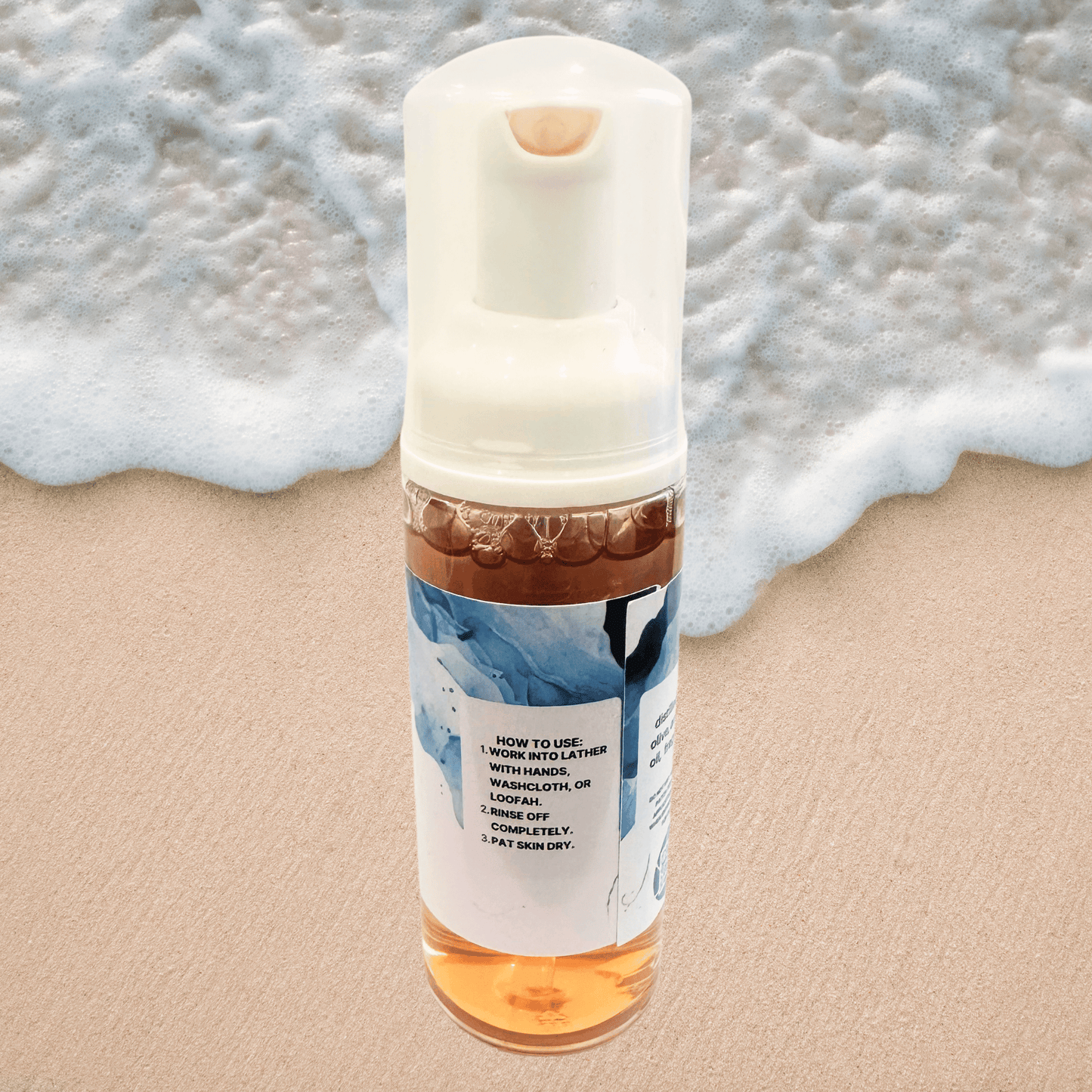 Foam bottle with directions label on a sandy background