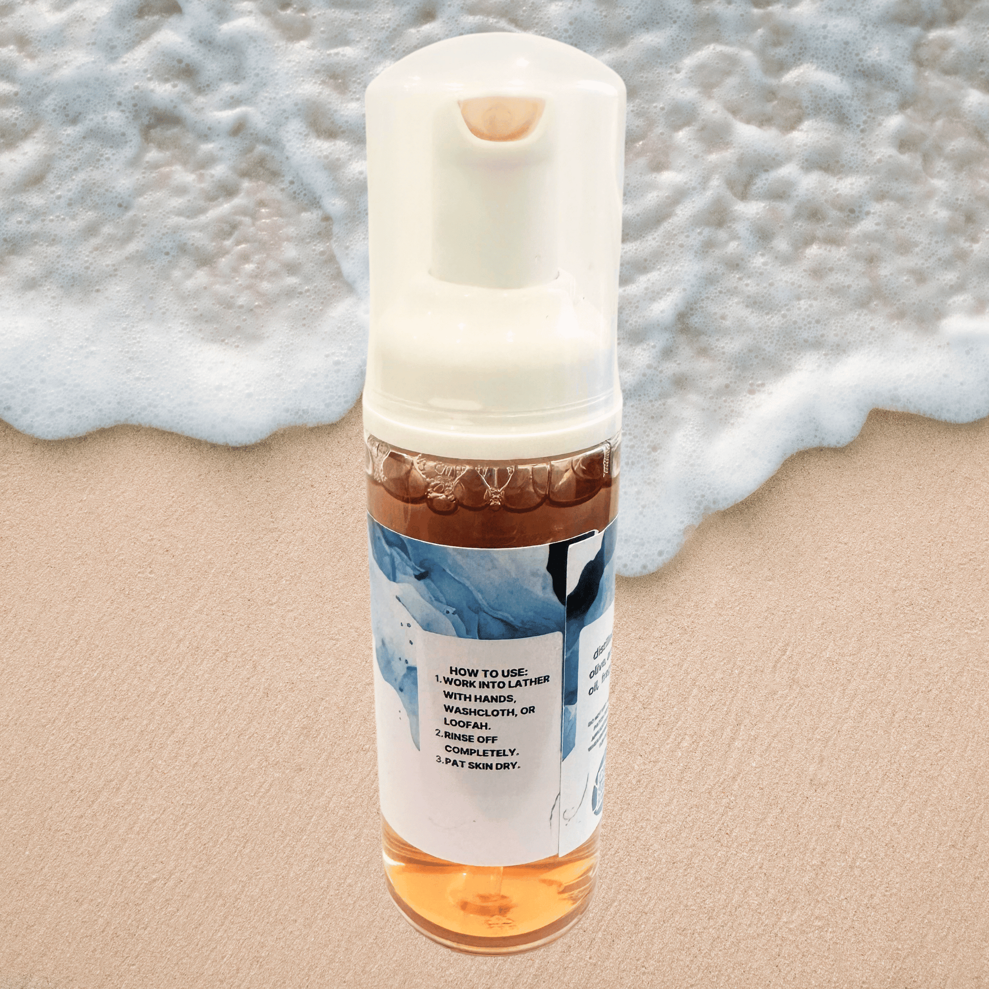 Foam bottle with directions label on a sandy background