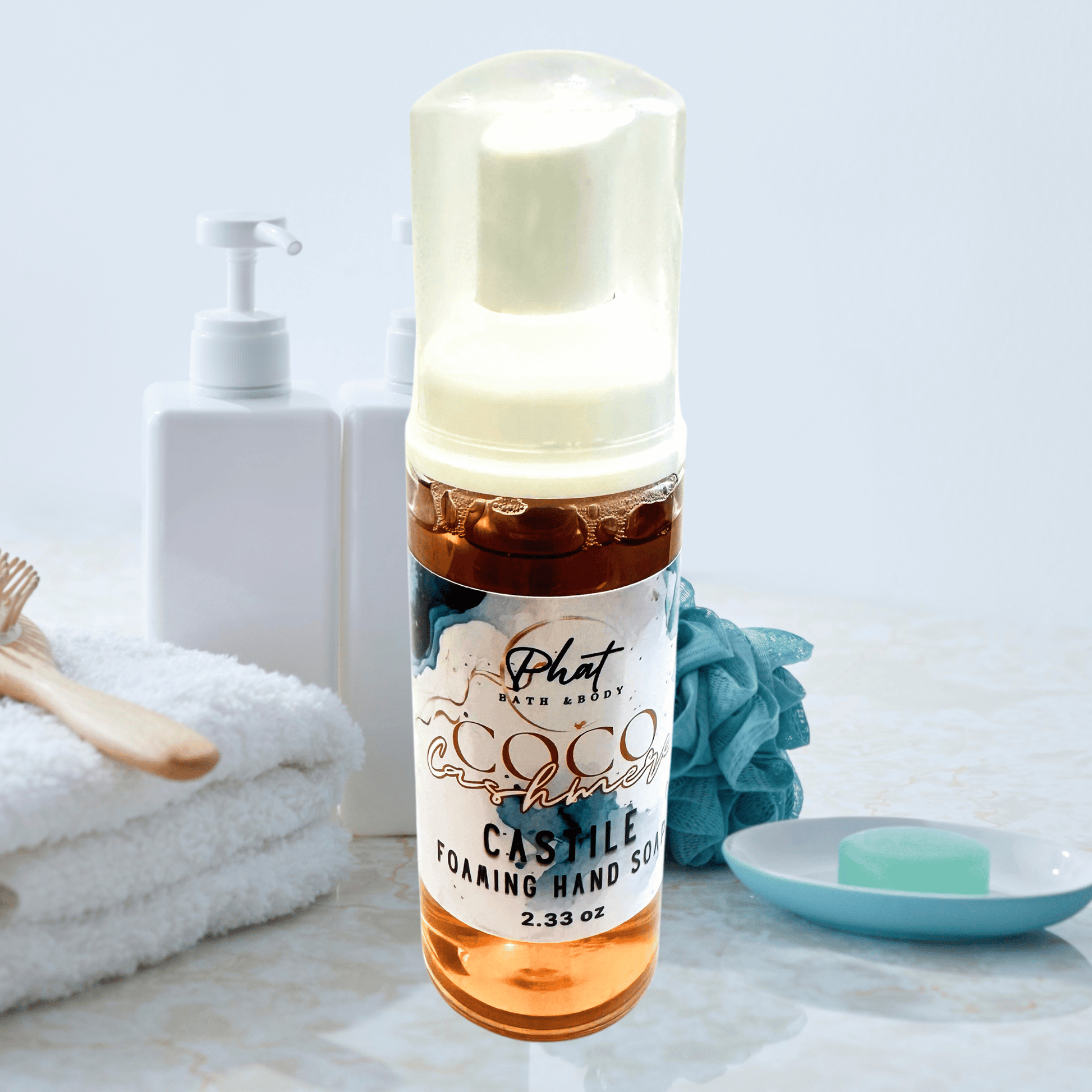 Bottle of Castile foaming hand soap with a white pump on a bathroom counter.