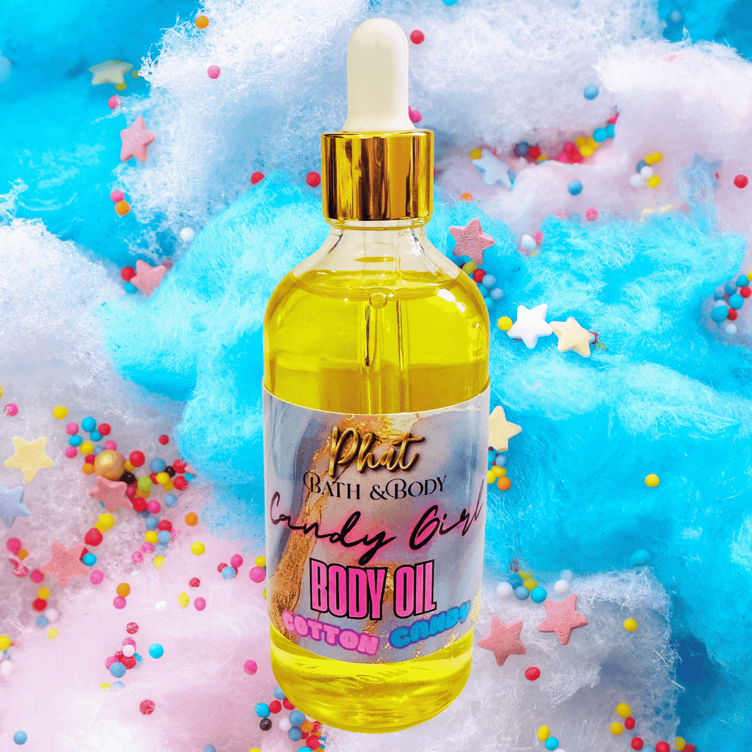 Bottle of 'Candy Girl' body oil with colorful confetti and cotton candy in the background