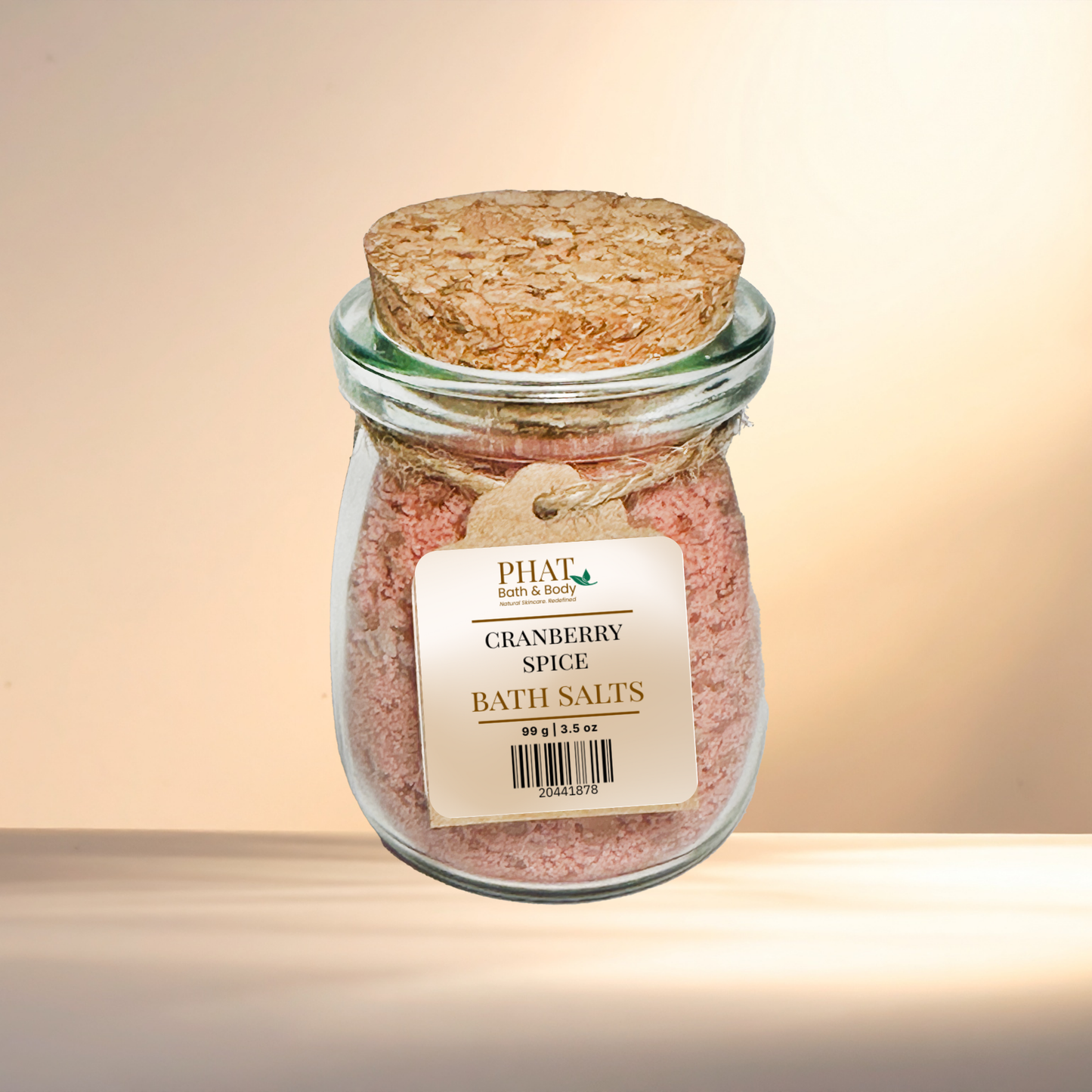 Jar of Cranberry Spice Bath Salts with cork lid on a gradient background