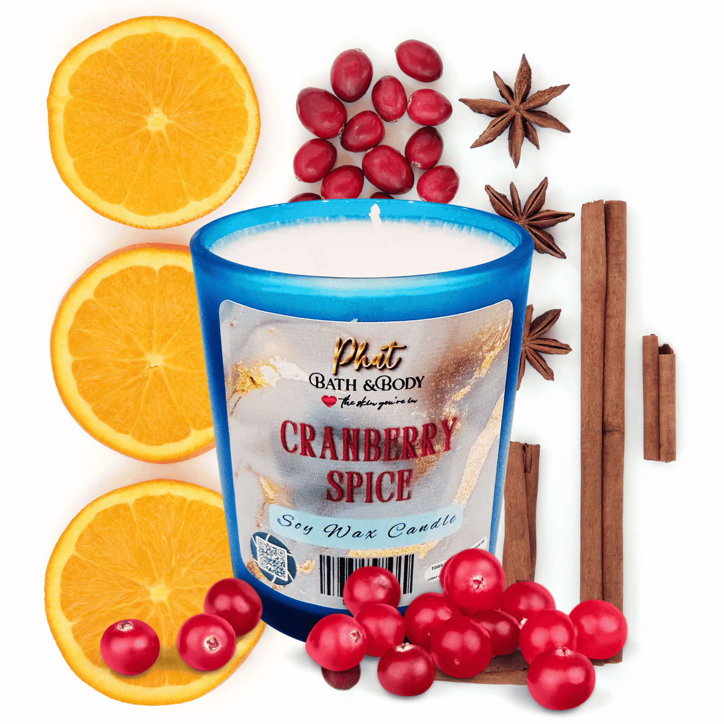 Cranberry Spice candle with oranges, cranberries, and cinnamon sticks on a white background