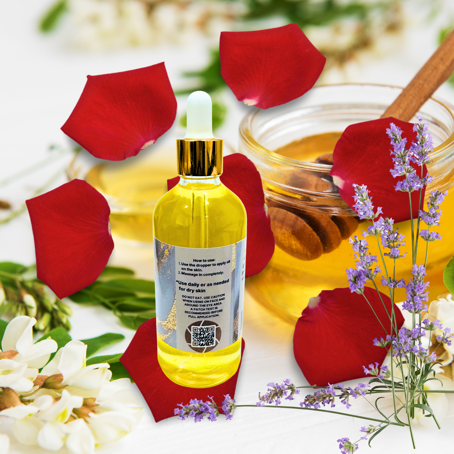 Bottle of oil with red rose petals and lavender flowers on a white background