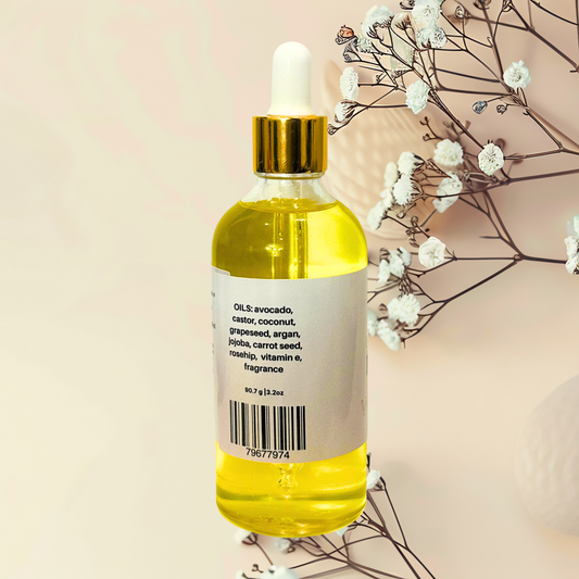 Bottle of yellow liquid with dropper on a beige background with white flowers