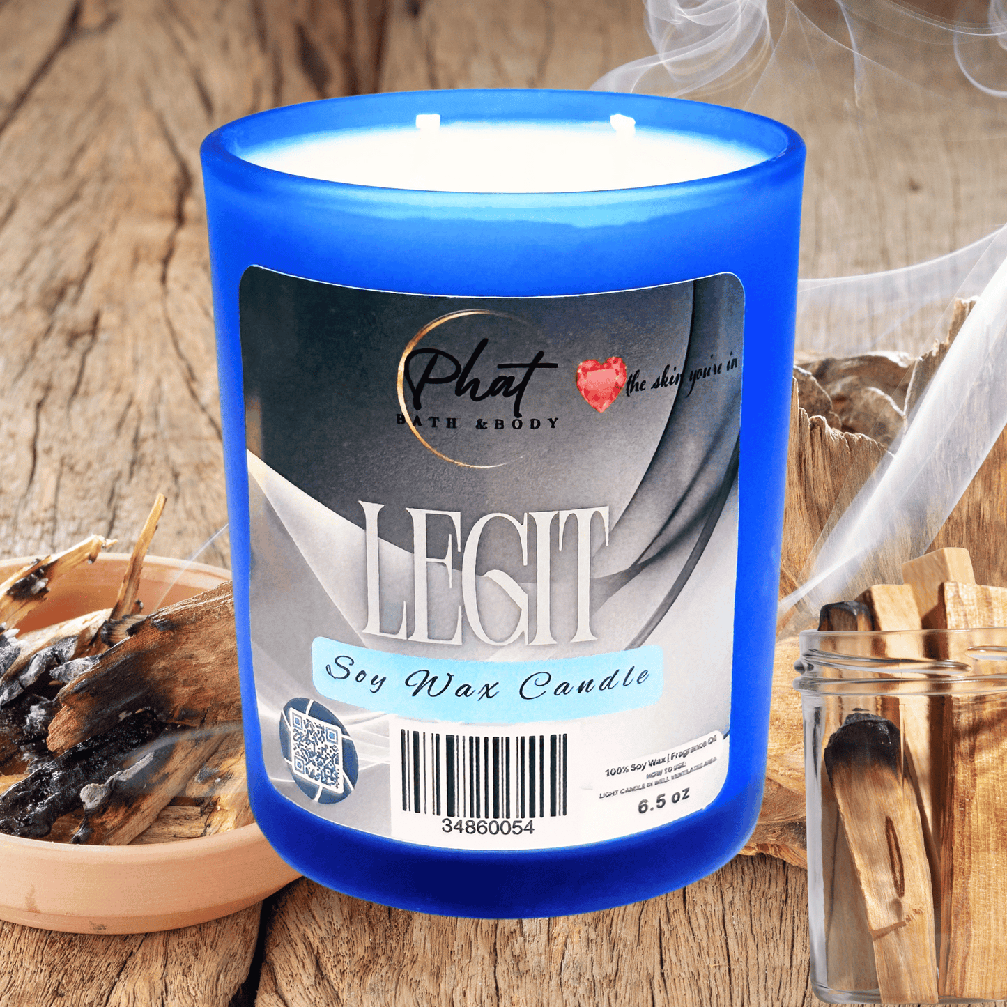 Blue candle labeled 'Legit' on a wooden surface with decorative items.
