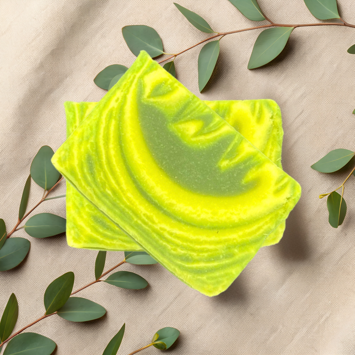 Green soap bar with leafy branches on a beige fabric background