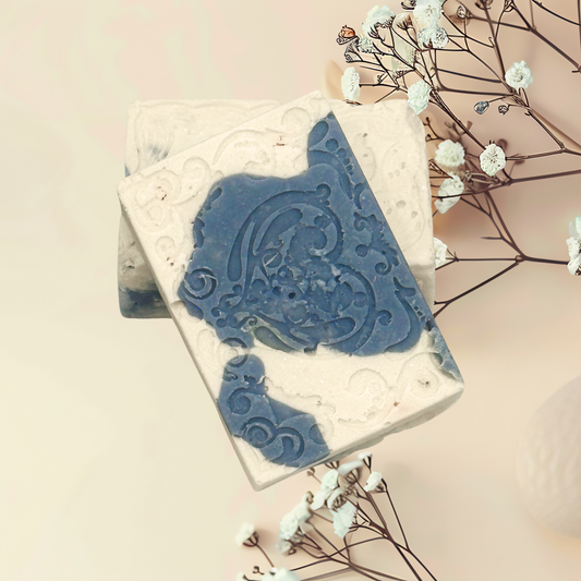Decorative soap with blue design on a white background with flowers