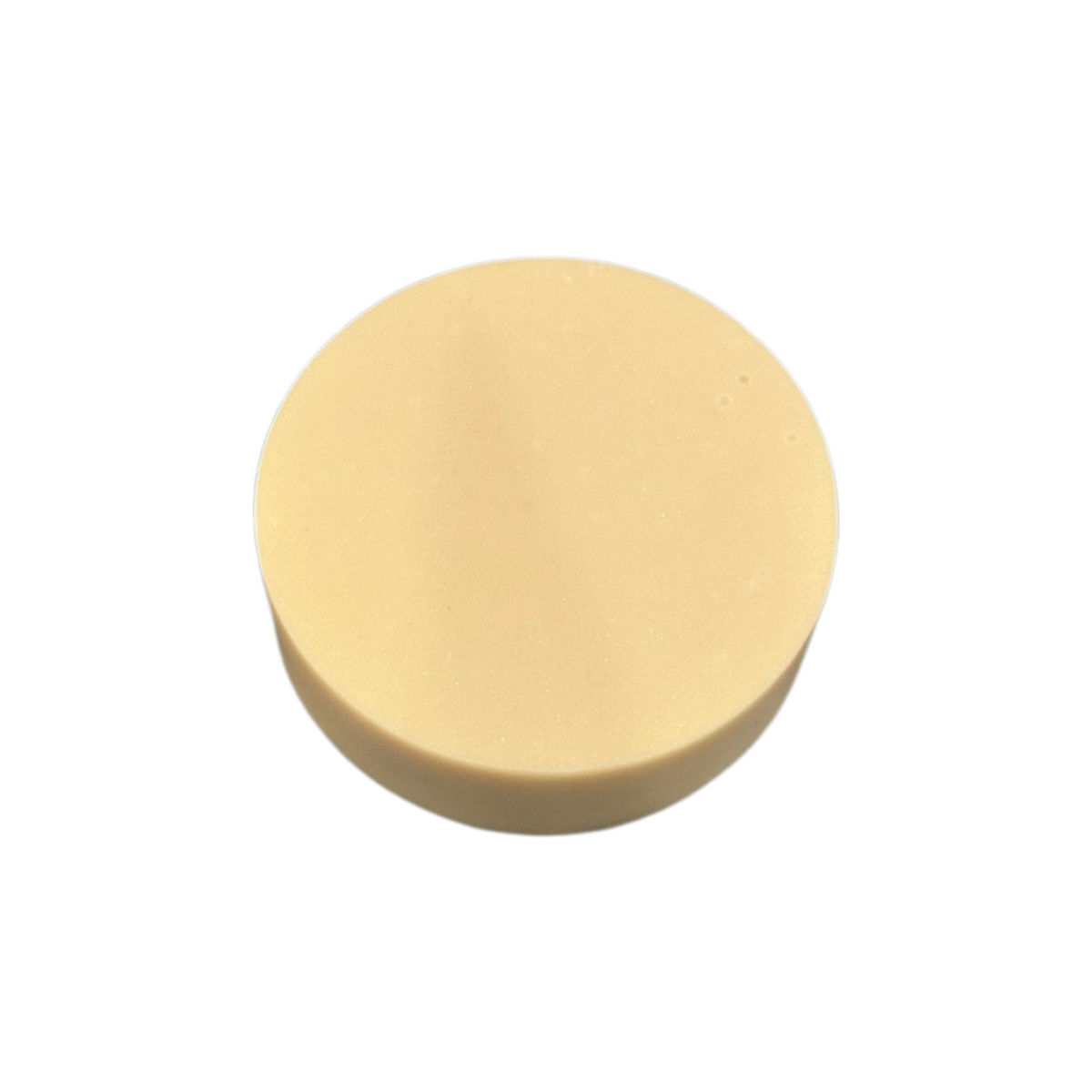 Round beige soap on a white background