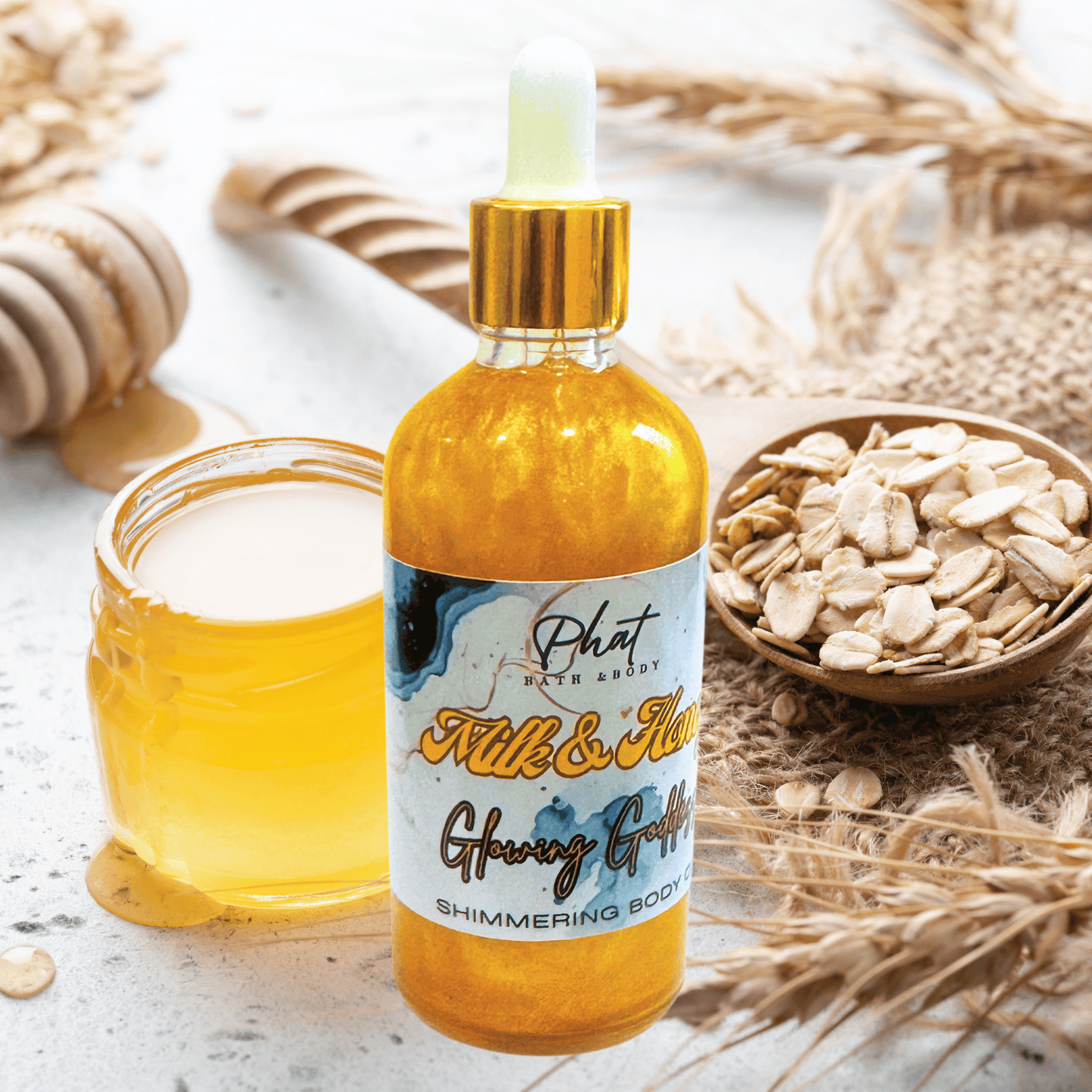 Bottle of 'Milk & Honey' shimmering body oil with a jar of honey and oats on a wooden surface.