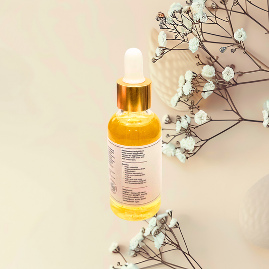 Yellow dropper bottle with a beige background and white flowers