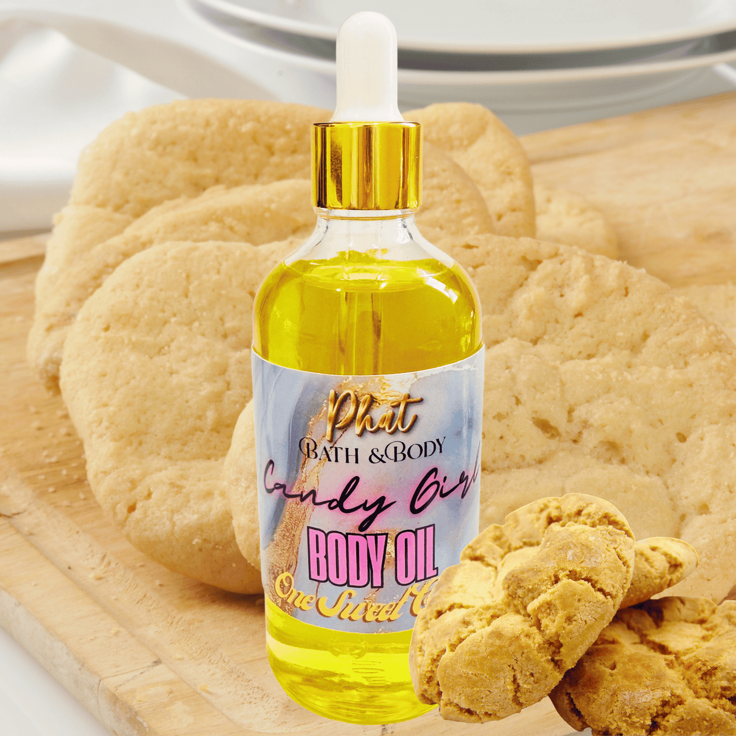 Body oil bottle with a gold cap and colorful label on a wooden surface with cookies.