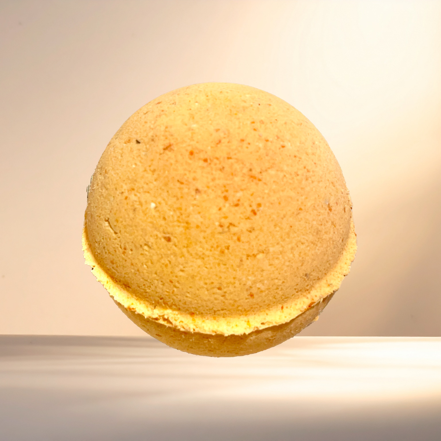 Round orange bath bomb on a neutral background