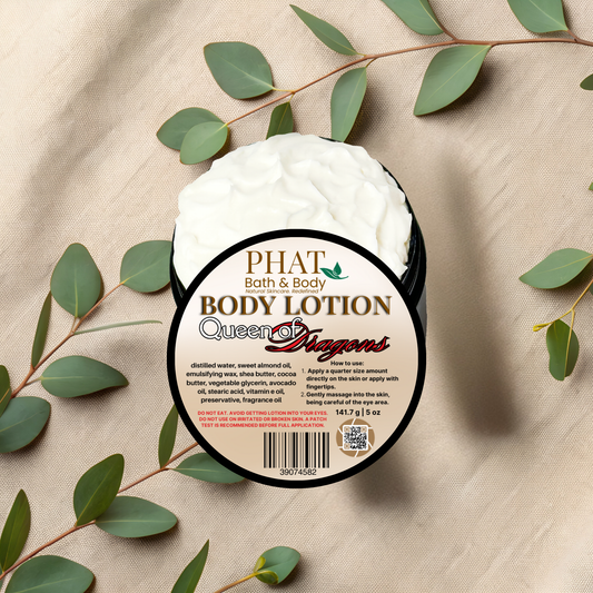 Body lotion container with 'Phat Bath & Body' branding on a beige fabric background with green leaves.