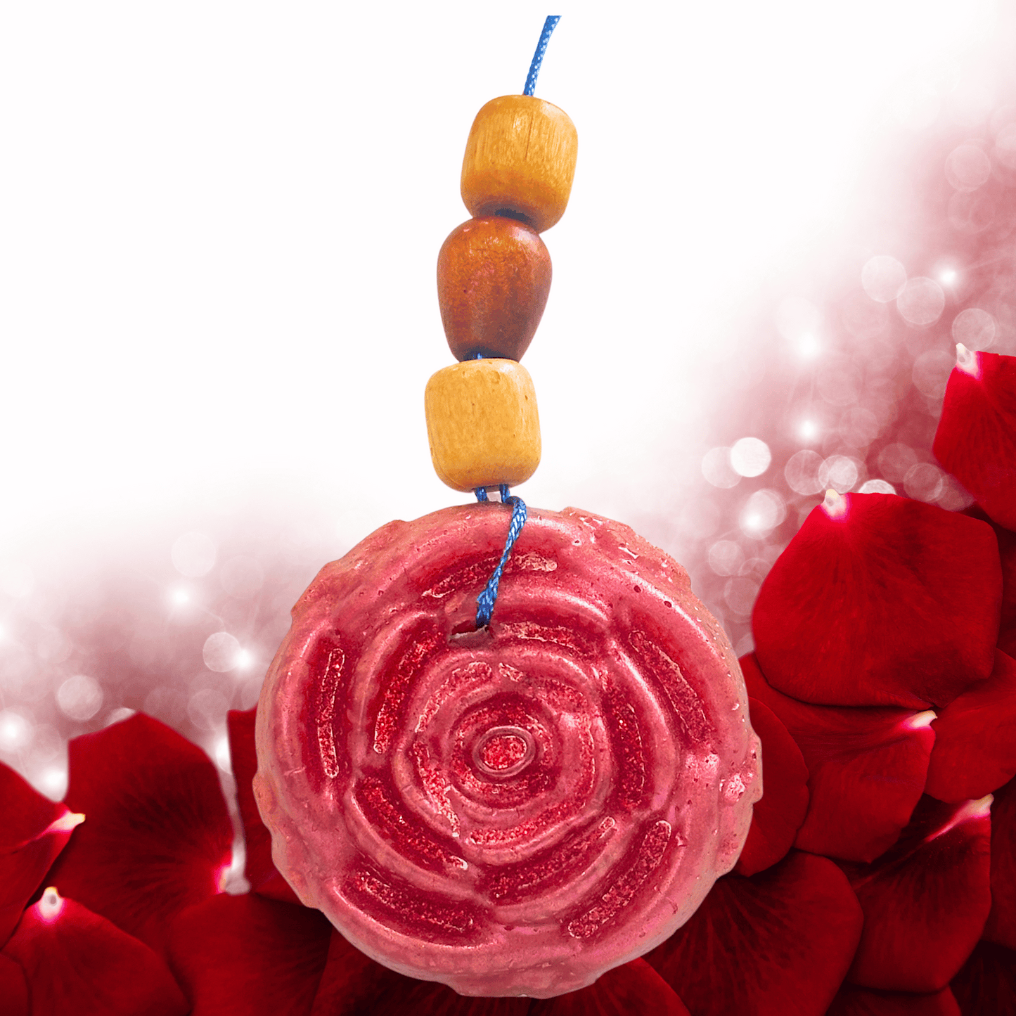 Decorative rose shape car freshie with wooden beads and a pink circular design on red floral background