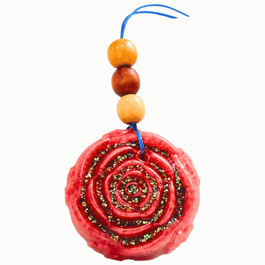 Red rose shaped car freshie with wooden beads on a white background