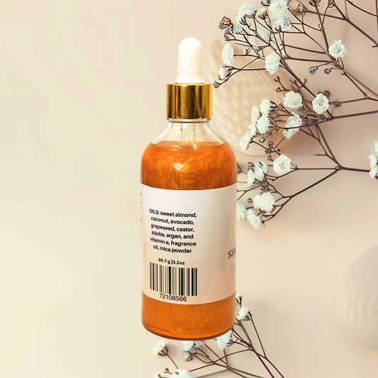 Bottle of gold liquid with a dropper on a beige background with white flowers.