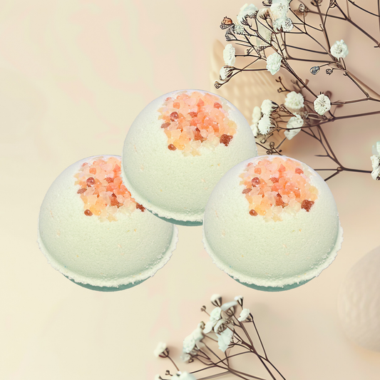 Three bath bombs with decorative elements on a light background