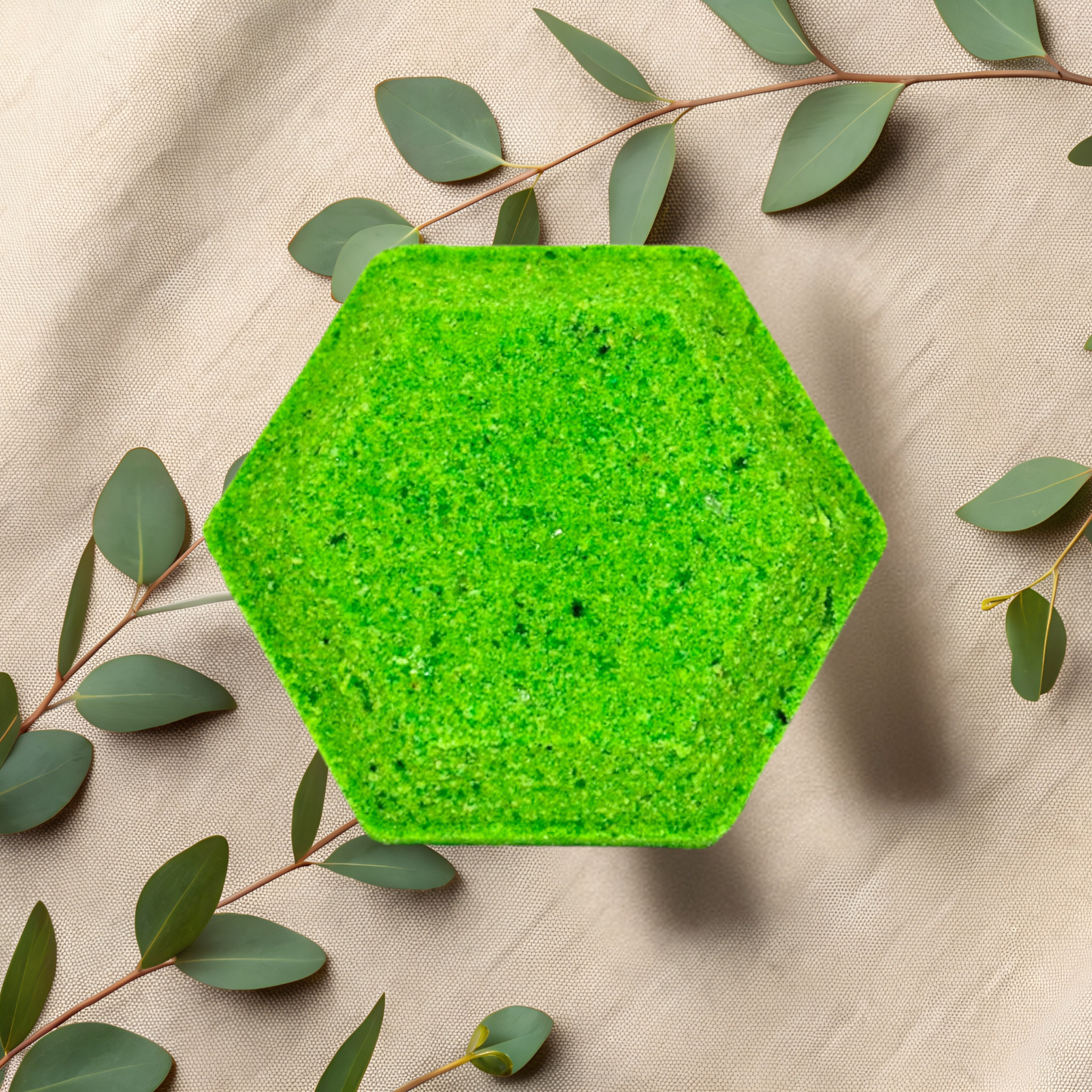 Hexagonal green steamer on a beige fabric background with green leaves