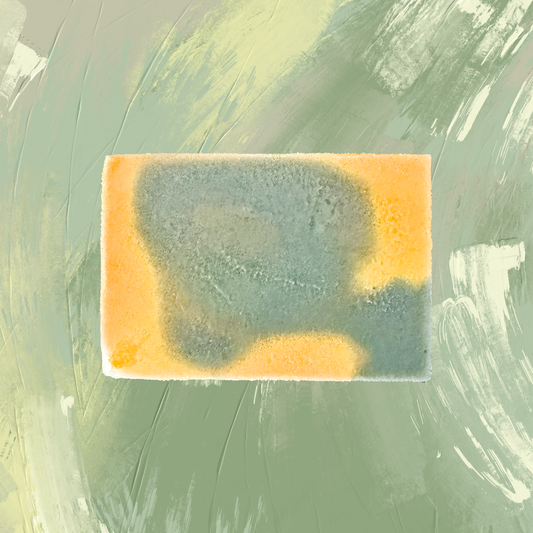 Rectangular bar of soap with green and yellow coloration on a textured green background