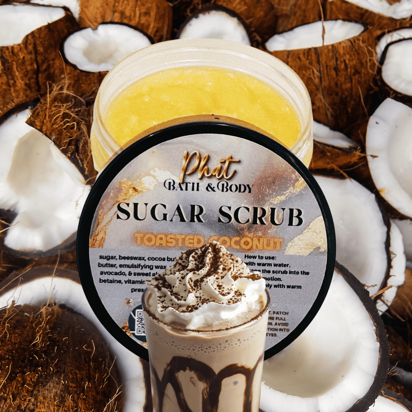 Jar of Phat Bath & Body Toasted Coconut Sugar Scrub surrounded by coconut halves.