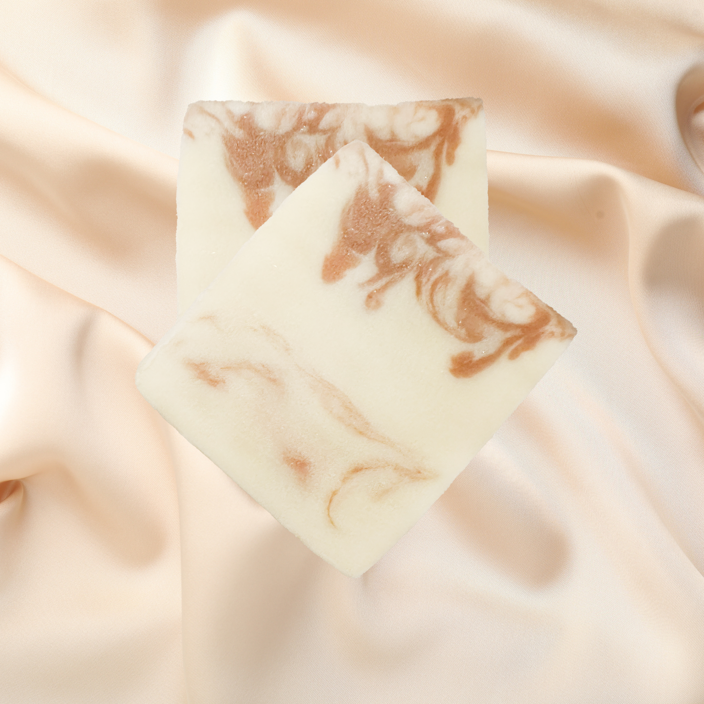 Marble-patterned soap bar on a soft fabric background