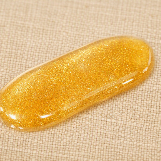 Shimmer body oil highlighting its luminous, reflective finish on skin.