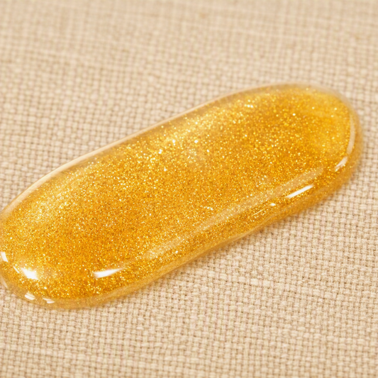 Shimmer body oil highlighting its luminous, reflective finish on skin.
