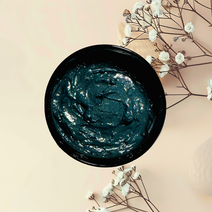 Black jar with black mask on a beige background with white flowers