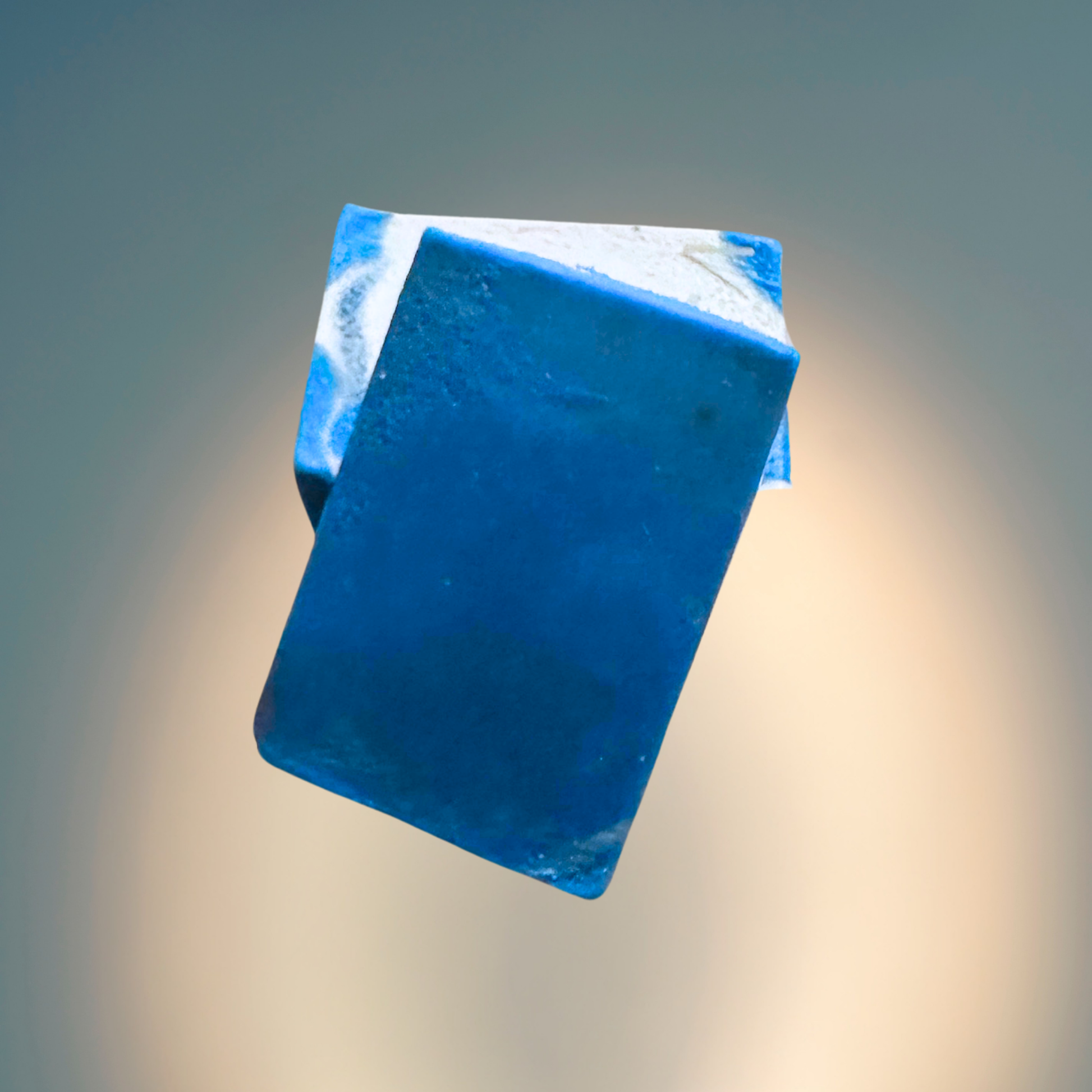 Blue and white soap bar on a gradient background