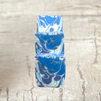Blue and white marbled soap bars on a textured beige background