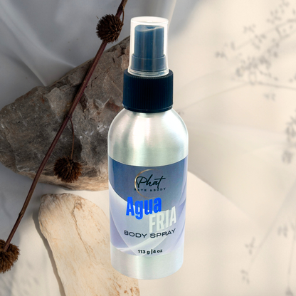 Body spray bottle labeled 'Agua Fria' on a natural stone surface with a blurred background