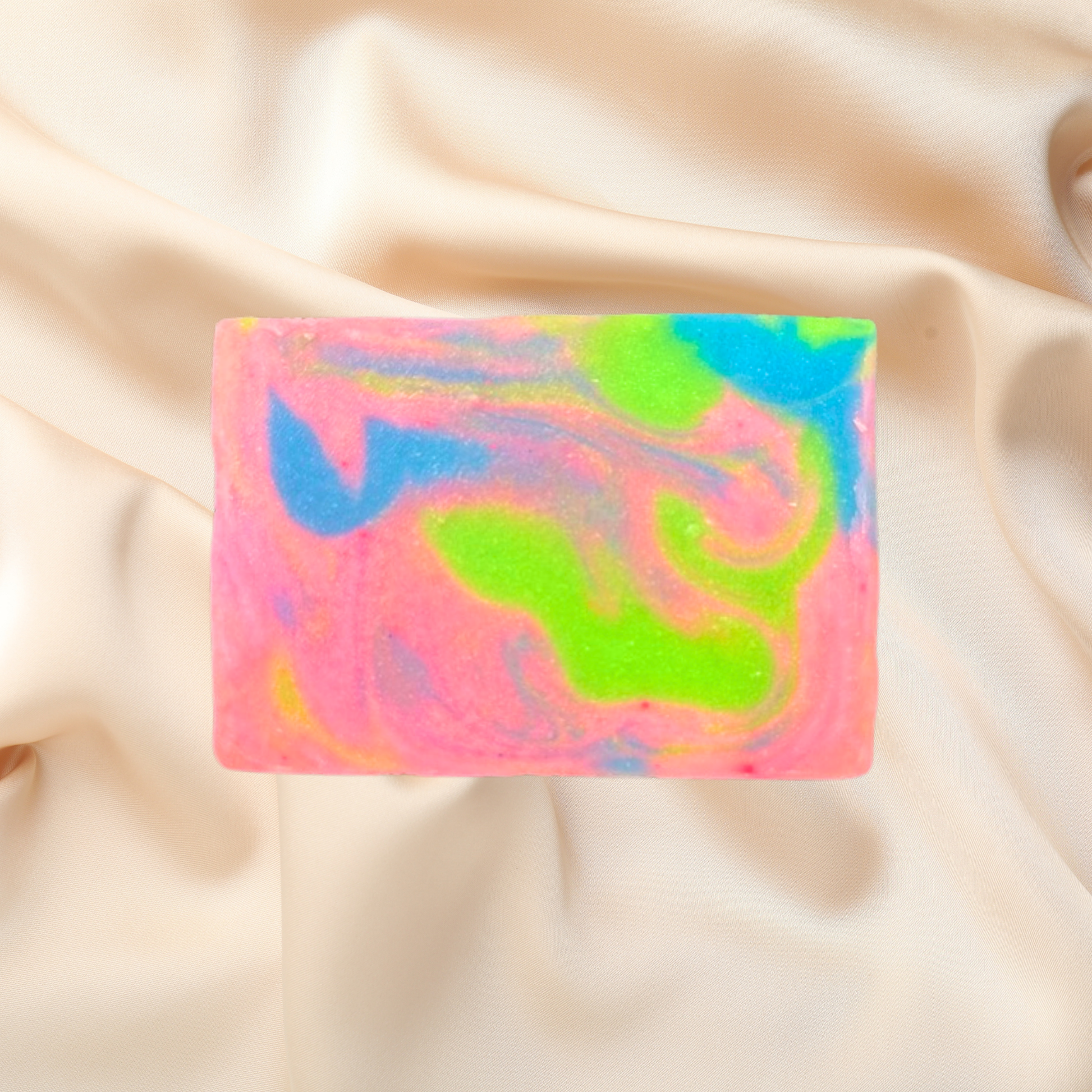 Colorful soap bar with a marbled pattern on a beige fabric background