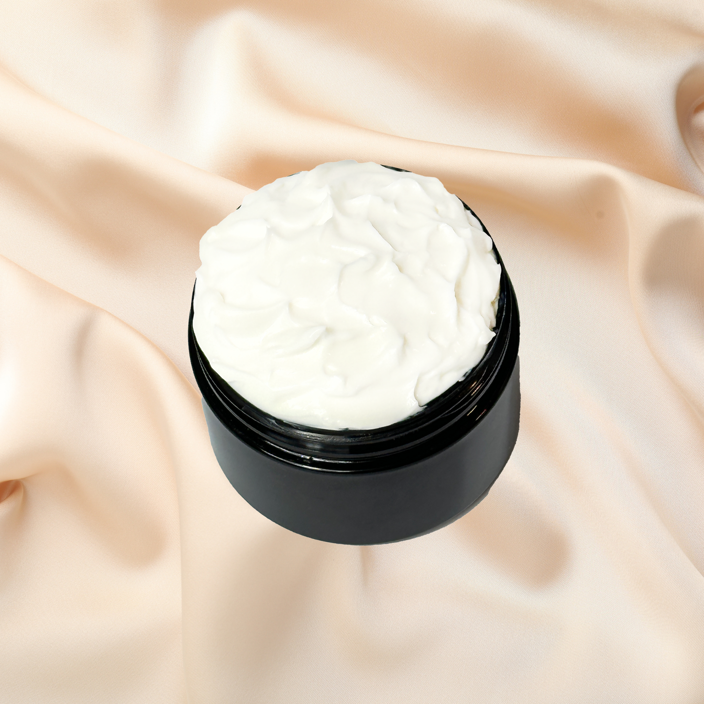 Black jar of white cream on a beige fabric background
