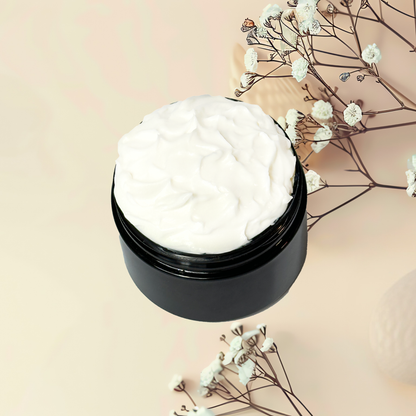 Black jar of white cream with dried flowers on a beige background