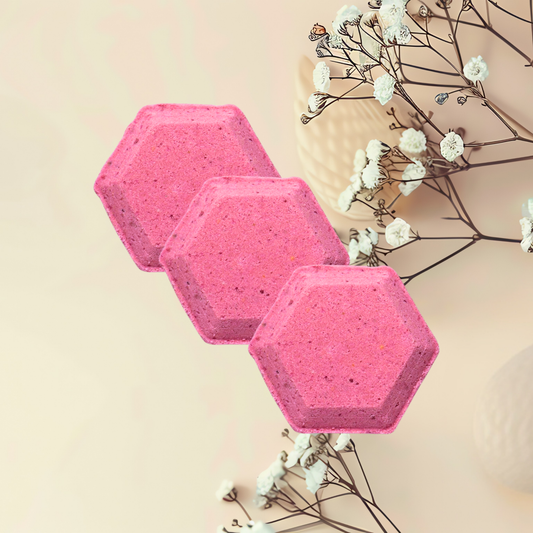 Three pink hexagonal steamers with white flowers on a beige background