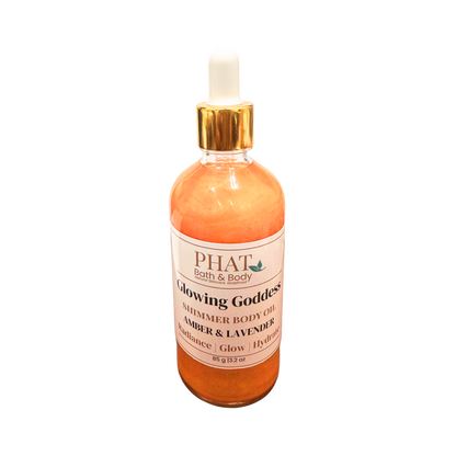 Bottle of 'Glowing Goddess' shimmer body oil by PHAT Bath & Body on a white background