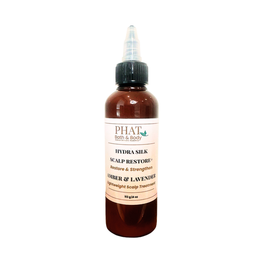 A amber bottle of PHAT Bath & Body Scalp Restore+ hair treatment with a black dropper cap and a cream-colored label, set against a plain white background.