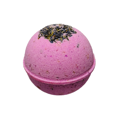 Purple bath bomb with lavender on top against a white background
