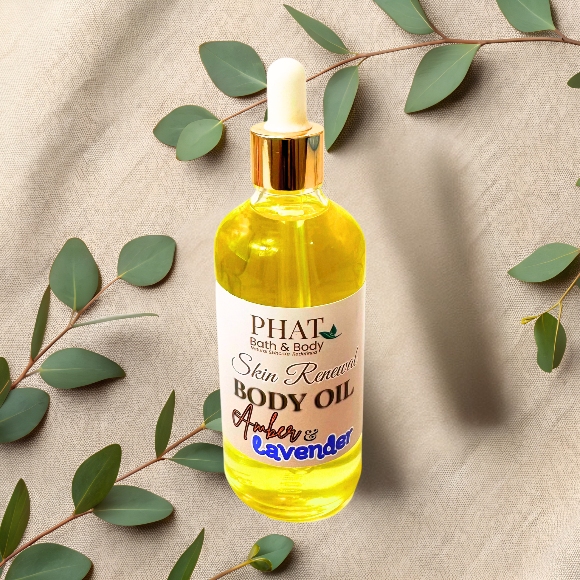 Bottle of PHAT Bath & Body skin renewal body oil with green leaves on a beige fabric background